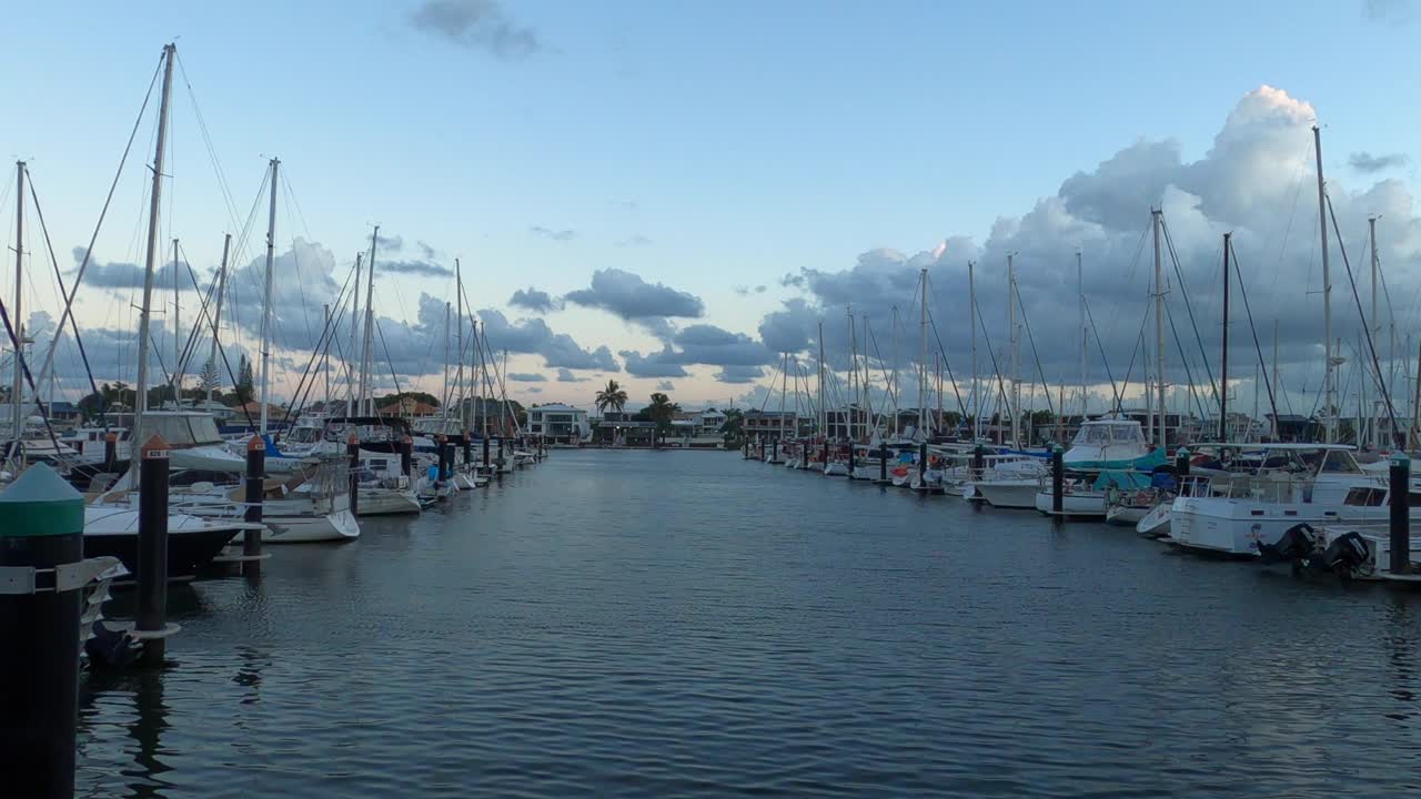 해질녘에 정박된 요트와 소형 보트가 있는 선착장