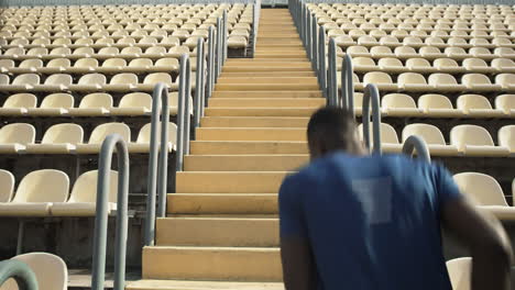 father and son running up stadium stairs