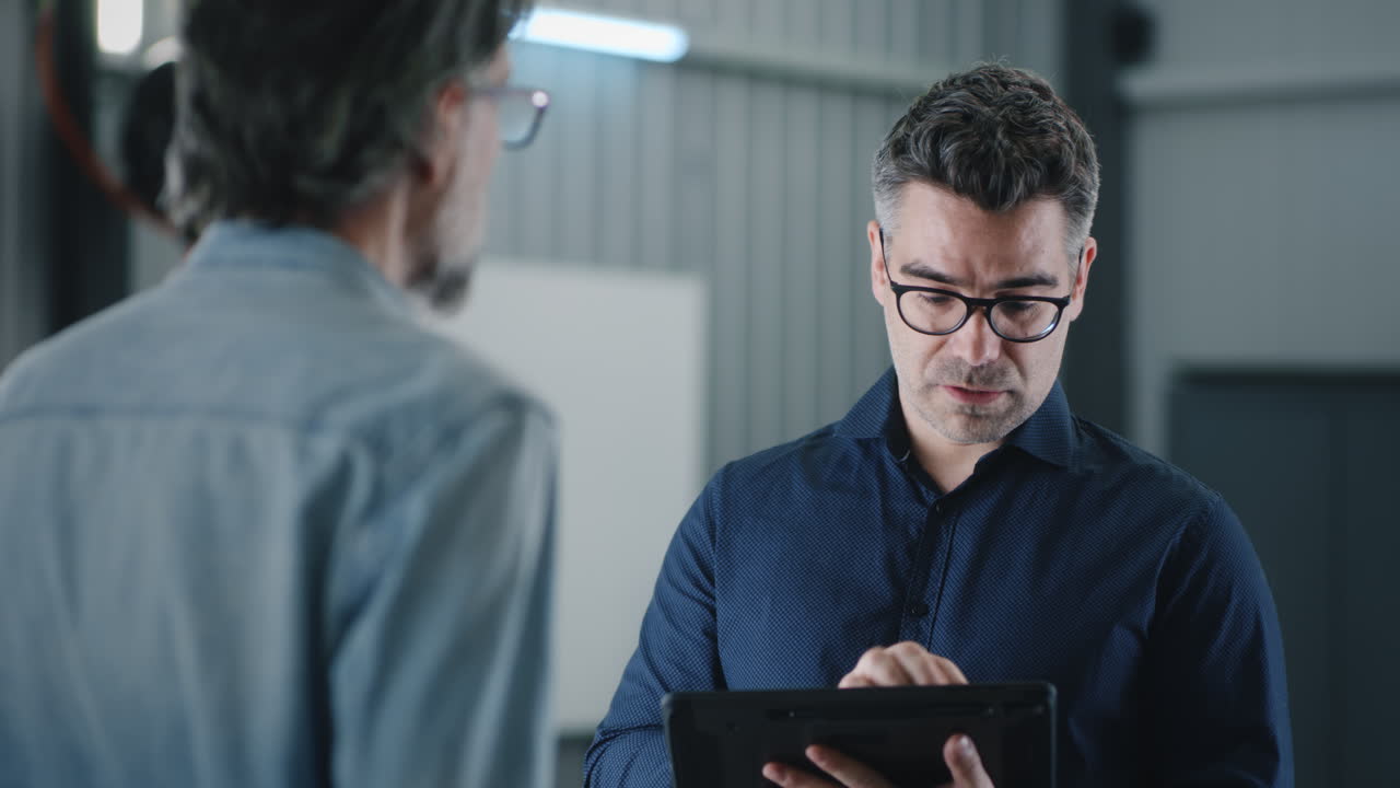 Male Worker and Female Manager Talking Using Tablet Computer Standing Outside of Logistics Warehouse