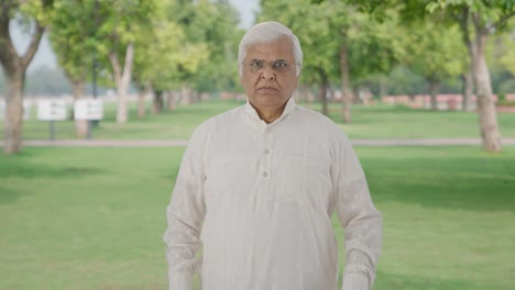 Angry-Indian-old-man-looking-at-the-camera-in-park