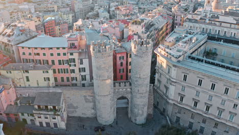 Drone-tilt-up-reveal-of-Porta-Soprana-in-heart-of-Genoa,-Italy