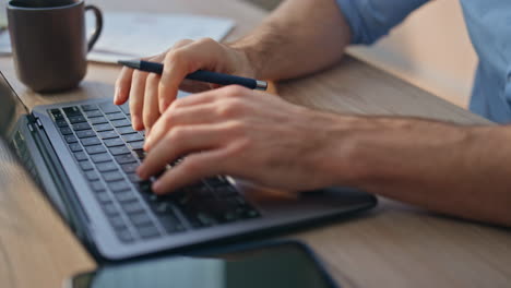 inspired man thinking solution working computer. closeup hands typing keyboard