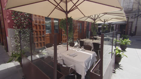 beautiful slow motion shot and general shot of a typical elegant bar terrace in madrid spain during a sunny morning with few people