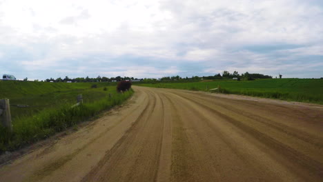 Car-driving-on-a-dirt-road-in-the-countryside