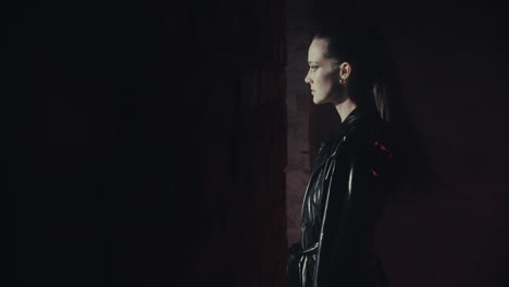 woman in leather jacket in a dark alley