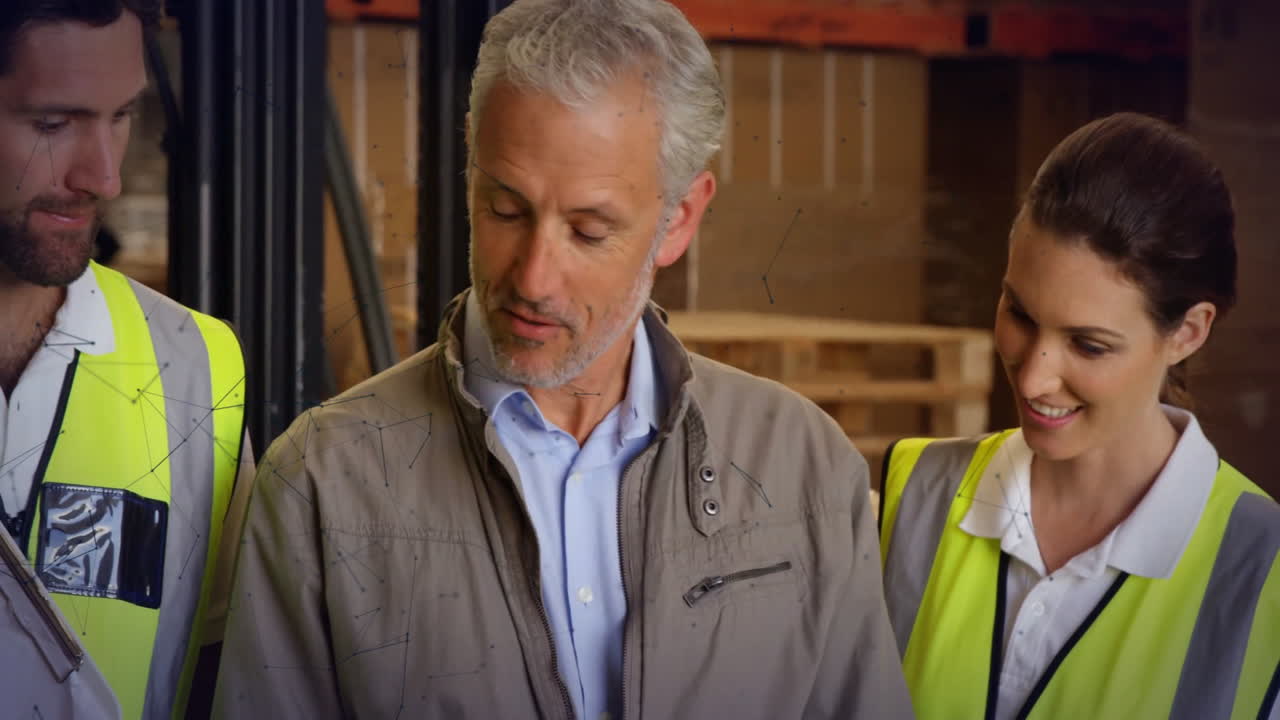 Diverse warehouse team discussing logistics with digital network animation overlay