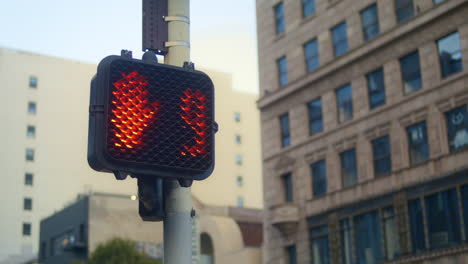 red stopsignal hand up on crosswalk city close up. regulation signal on pole