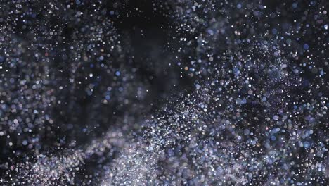 the blue sparkling particles falling in the air. slow motion