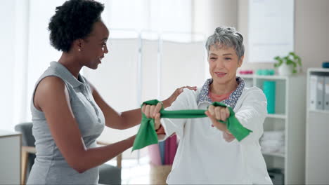 senior woman exercising with resistance band with physical therapist
