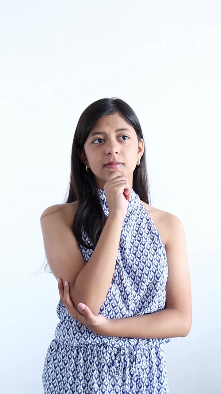 Young Woman Expressing Confusion and Stress Against White Background