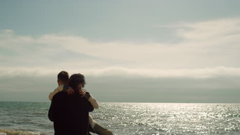 joyful couple have fun together on vacation sea beach. young people love nature