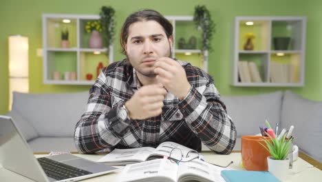 Young-man-looking-at-his-face-and-skin.