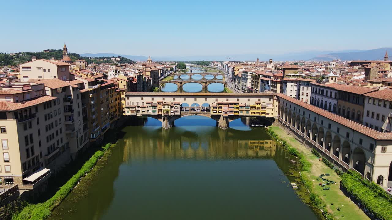 Drone pulls back from Florence’s Ponte Vecchio showing full river symmetry
