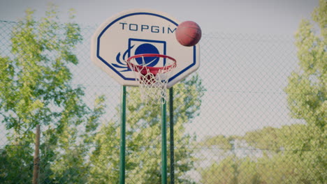 basketball court redhead girl dribbles ball in slow motion shoots and scores