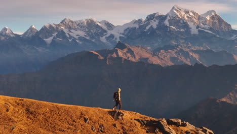 Drone-Shot-A-male-tourist-travels-ridge-of-Nepal-Everest-Mountain-range-at-PikeyPeak-landscape-4K