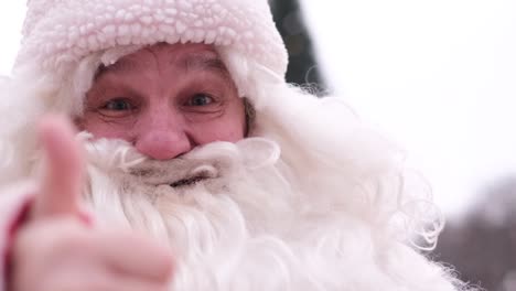 senior santa claus with a big white beard showing thumbs up handsome happy man senior santa claus with a big white beard showing thumbs up handsome happy man happy with the result the concept of christmas 2023