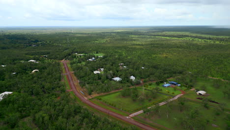 Aerial-Drone-of-Rural-Estate-Outback-With-Cloud-Shadows-on-Forest-and-Dirt-Road,-Howard-Springs-Darwin-NT-Australia