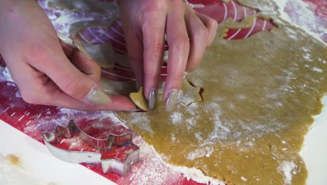 Close-shot-of-a-woman-getting-falling-star-shaped-uncooked-gingerbread-cookie