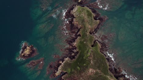 top shot from a drone over gwin zegal island next to the gwin zegal marina, bird eye view over the rugged coastline of the brittany coast in france