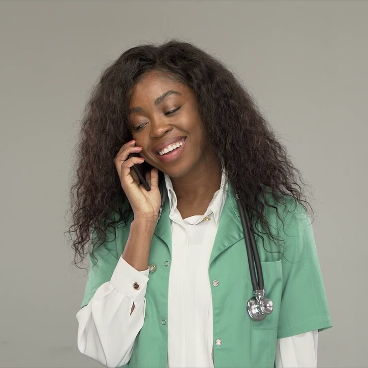 Happy doctor speaking on smartphone