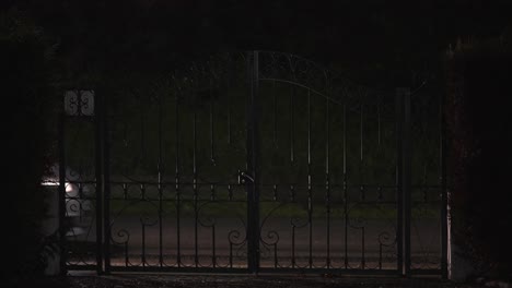 Nighttime-View-of-Cars-Passing-by-a-Gated-Entry