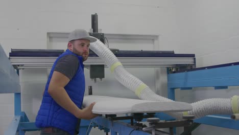 male surfboard maker in his workshop