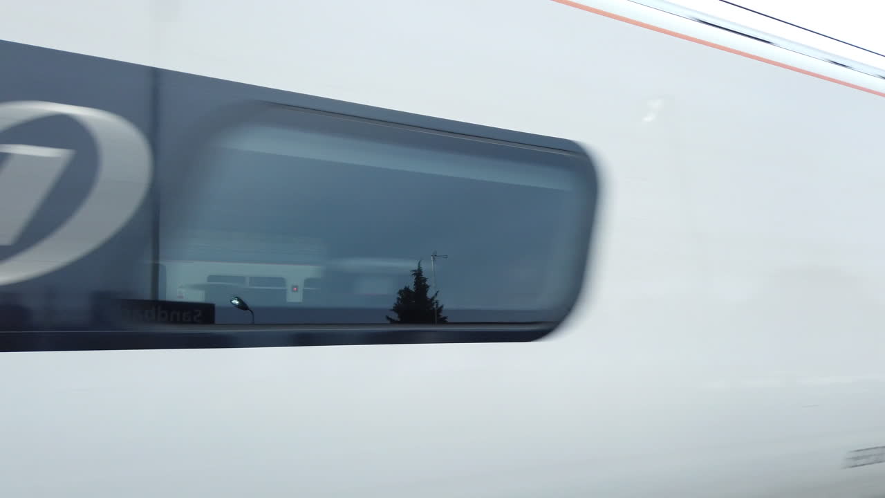 Train at sandbach station.waiting or moving. Poeple boarding