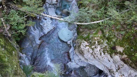 Cold-clear-water-forms-stunning-sculpted-limestone-slot-canyon-in-mtns