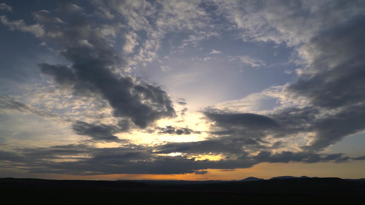 Time Lapse of Dramatic Clouds Moving Over a Sunset Horizon