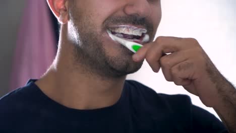 man brushing his teeth