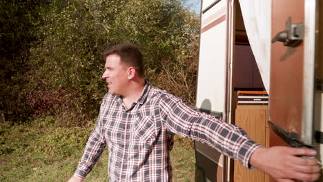 smiling couple getting out of their retro camper van