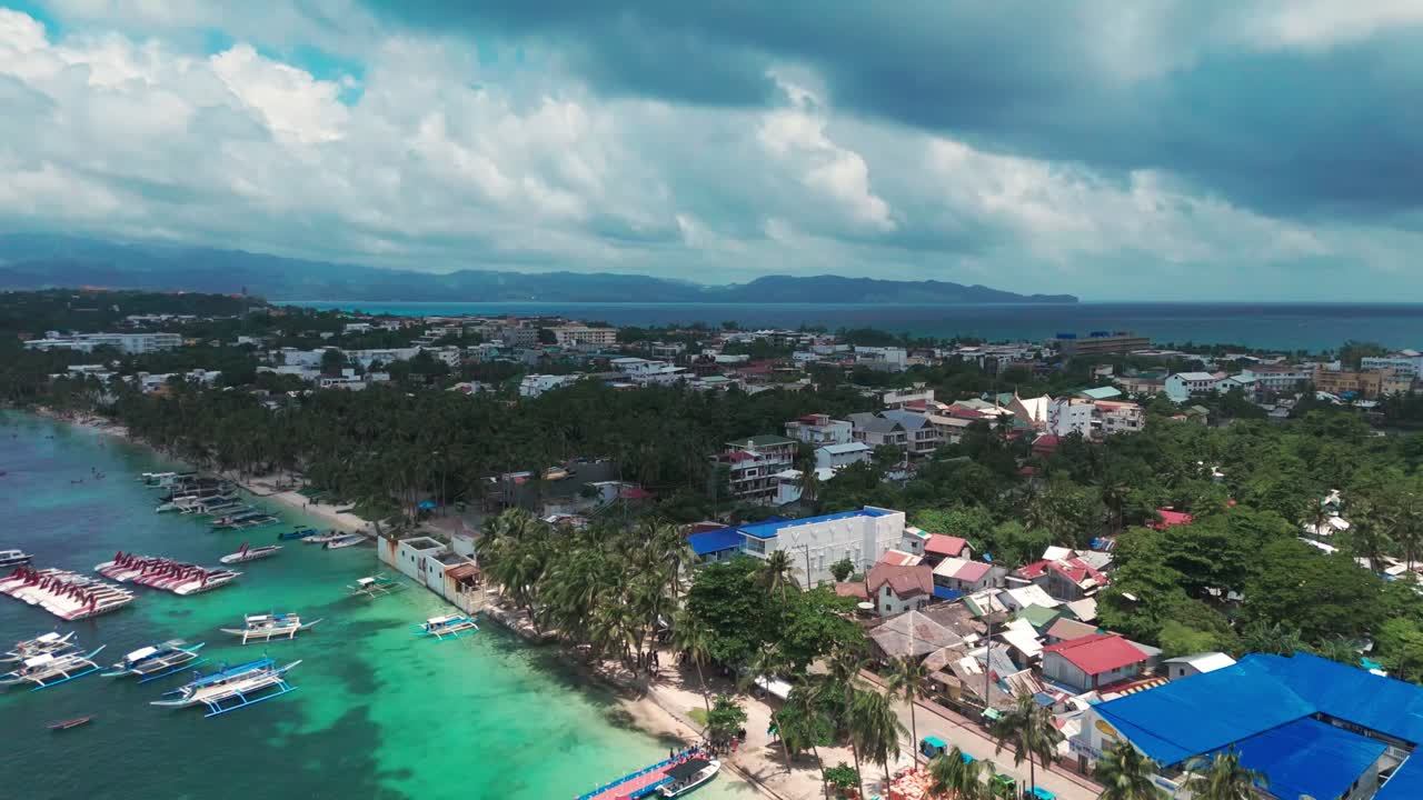 Beautiful 4K drone view of Boracay’s coastal town, palm-lined White Beach, and turquoise waters—ideal for tourism, travel promotions, and tropical destination content in the Philippines
