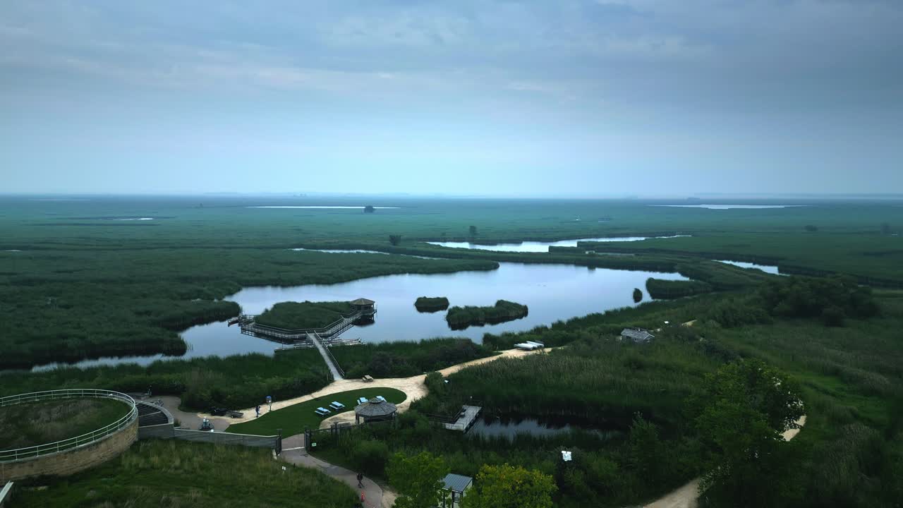Slow Aerial Establishing Shot of Canadian Marshland with Lakes and Paths
