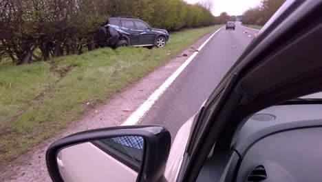 driving past a car crash with car skidded off road