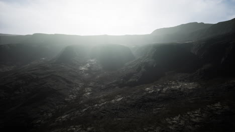 black mountains in deep fog