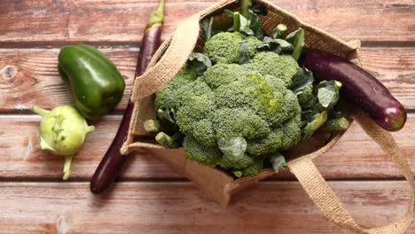 vegetables in a jute bag on wooden table