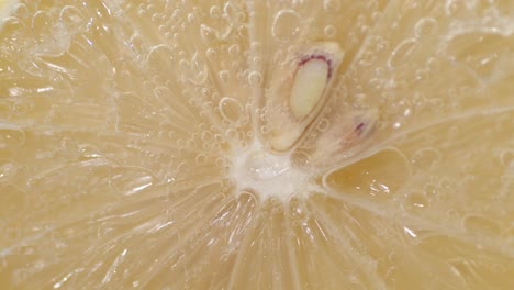 fresh lemon in water with air bubbles.