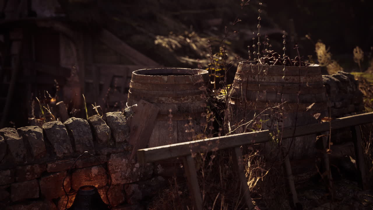 Rustic clay pots surrounded by dry grass in an old countryside setting at dusk