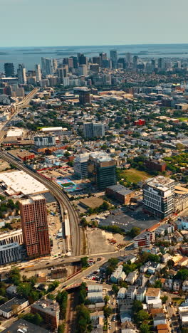 mainly low-rise architecture in the scenery of cambridge, massachusetts, usa. sunny view of the city from top. river at backdrop. vertical video