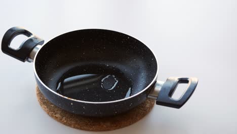 empty black frying pan with oil