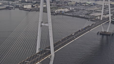 Nagoya-Japan-Aerial-v10-zoomed-flyover-port-harbor-capturing-Meiko-Chuo-Bridge-traffic,-views-of-Shiomicho-industrial-sector-and-Minato-ward-cityscape---Shot-with-Mavic-3-Pro-Cine---October-2023