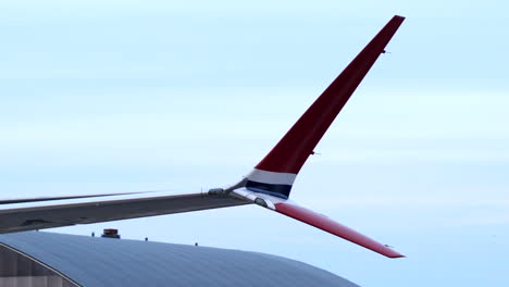 red colored split tip winglet of airliner, isolated close up