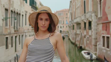 happy female traveler on bridge over canal