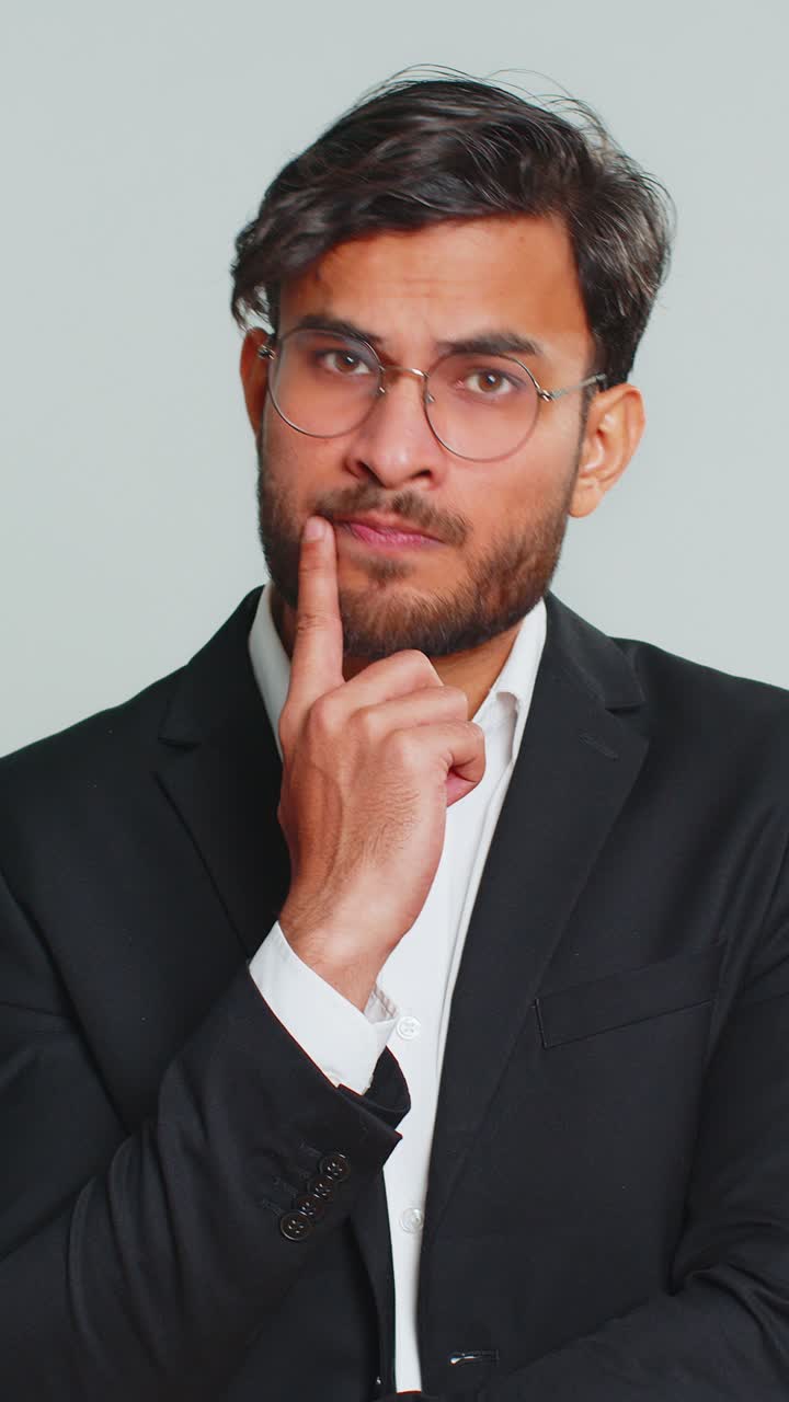 Indian business man pondering imagining in mind wondering difficult solution answer question