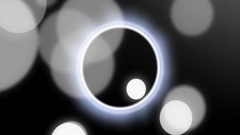 animation of white and black spots moving over black background