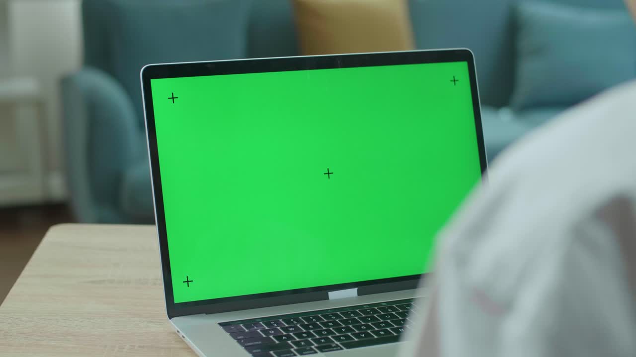 Close Up Of Asian Man Student  Waving Hand And Talking To Green Screen Computer At Home