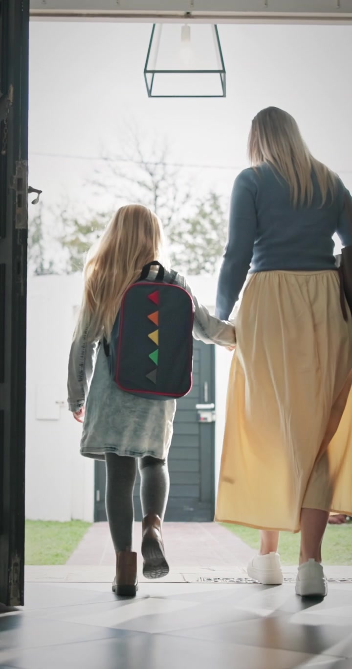 Mother and Daughter Walking Out of Front Door Together