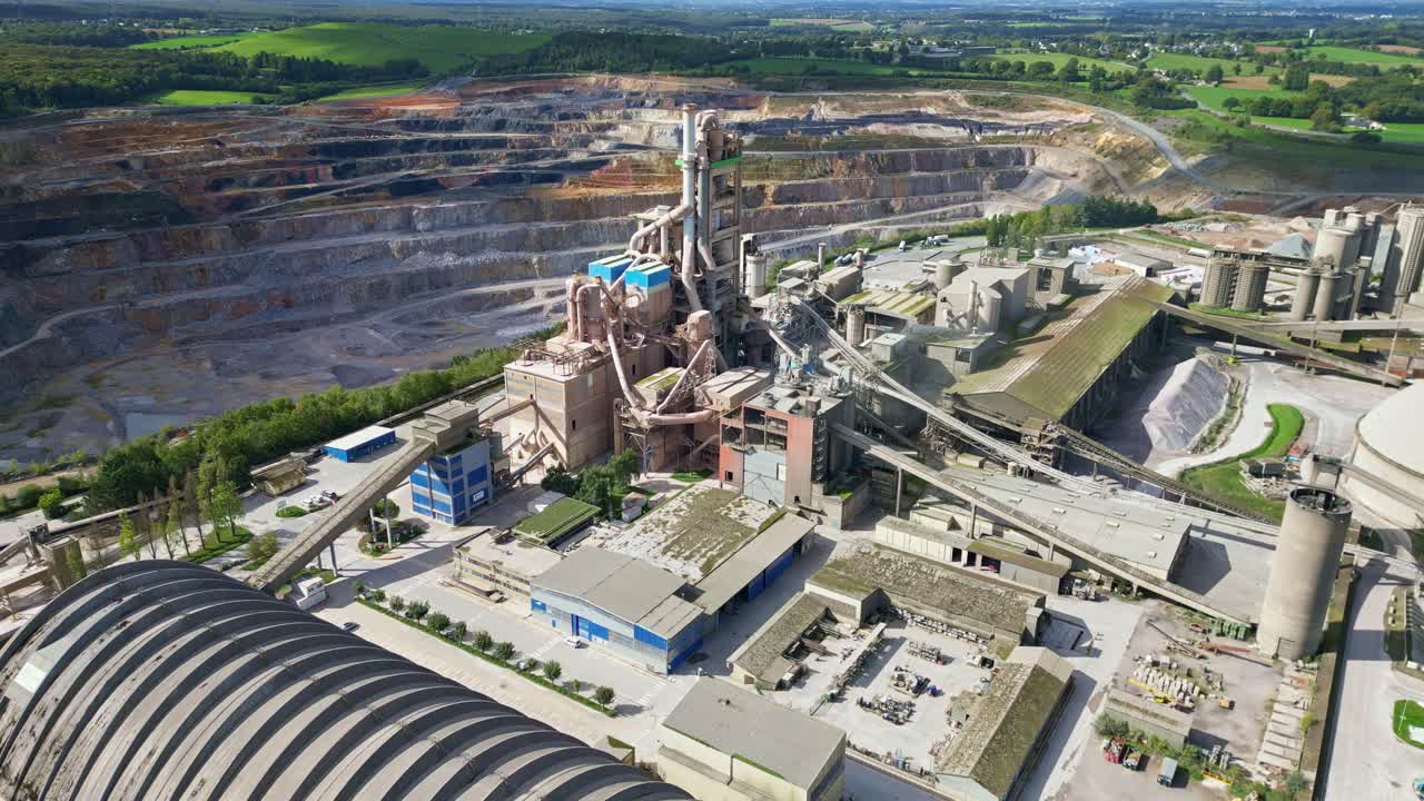 Wide aerial dolly of cement plant layout and surrounding roads in Saint Pierre la Cour France