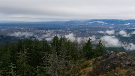 low clouds cover city in morning, drone shot rising, eugene, oregon