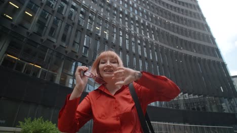 young woman in red shirt and sunglasses in a city